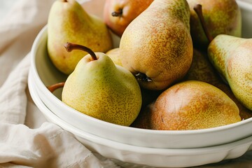 Ripe pears in a white bowl on the windowsill.