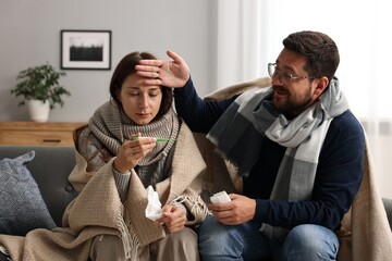 Canvas Print - Cold symptom. Couple suffering from fever on sofa at home