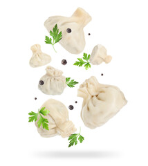 Wall Mural - Delicious khinkali (Georgian dumplings), peppercorns and parsley falling on white background