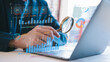 © cherdchai - businessman holding magnifying glass looking at virtual data chart dashboard in concept of investment data analysis and DMS document audit financial Tax Fraud audit Using Magnifying Glass