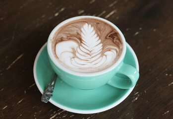 Hot chocolate on wooden table in cafe