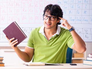 Poster - Young male student chemist in front of periodic table