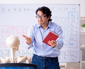 Wall Mural - Young male chemist teacher and student skeleton