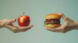 © Junaid - apple and a hamburger, both held in hands