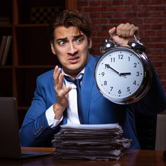 Wall Mural - Young businessman working in the office at night