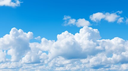 Poster - Puffy cumulus clouds in a bright blue sky with plenty of room for copy