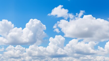 Poster - Puffy cumulus clouds in a bright blue sky with plenty of room for copy