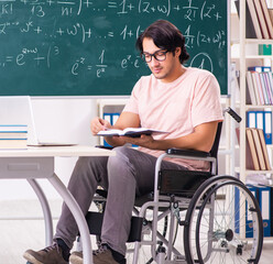 Sticker - Young handsome man in wheelchair in front of chalkboard