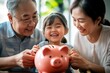 © SHI - The little girl makes a family piggy bank with her grandparents. They use the piggy bank provided to save money. Represents the traditional wisdom of family wealth accumulation