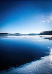 Poster - A serene lake reflects the clear blue sky and distant trees.