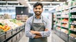 © N7 - 'Indian Retail Worker in Grocery Store Uniform' - A portrait of an Indian retail worker in uniform, standing in a grocery store, ready to assist customers.