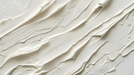 Poster - A close-up image reveals the textured surface of a white canvas painted with thick, creamy strokes of paint. The swirls and ridges of the paint create a dynamic and interesting abstract pattern.