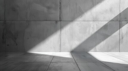 A gray concrete wall and floor are illuminated by a bright beam of sunlight streaming in from an unseen window, casting sharp, diagonal shadows across the surface.