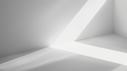 Aufkleber - Sunlight streams through a corner window in a white room, creating long, diagonal shadows on the walls and floor. The room is otherwise empty, making the light the focal point of the image.