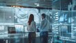 © kinara art design - Two business people stand in front of a large window in an office, discussing data displayed on multiple monitors.