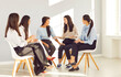 © Studio Romantic - Group of female business people women discussing work project or talking with psychologist on therapy session sitting in a circle in office. Team work or psychological assistance to company employees