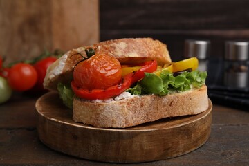 Wall Mural - Tasty sandwich with grilled vegetables on wooden table, closeup