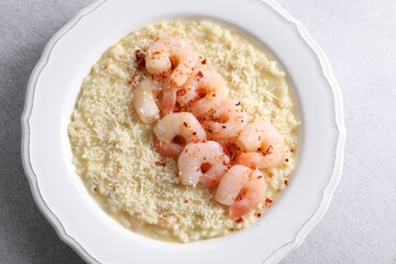 Poster - Delicious risotto with shrimps and cheese on light grey table, top view