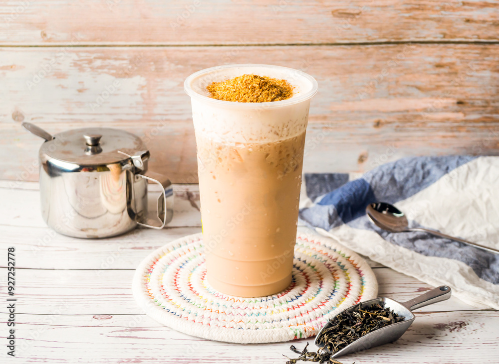 Iced Wheat Germ Milk Tea with sugar pot and spoon served in disposable ...