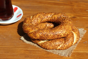 Wall Mural - turkish tea and turkish bagels (simit) on wooden table