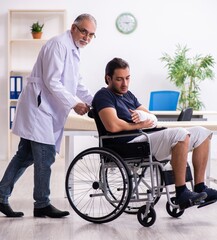 Wall Mural - Young injured man visiting experienced male doctor traumatologis