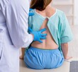 © Elnur - Young back injured woman visiting male doctor chiropractor