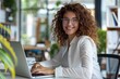 © Alona - Happy Student On Computer. Smiling Female Student Using Laptop in Corporate Office for Online Learning and Web Research