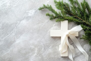 Wall Mural - White christianity wooden cross with white silk ribbon and green fir branch on a light grey marble background with copy space. Christmas holidays. Christian religion background. Flat lay, ai