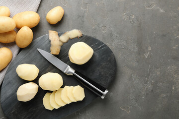 Poster - Fresh raw potatoes and knife on grey table, top view. Space for text