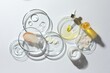 © New Africa - Petri dishes with different cosmetic products on white background, flat lay