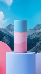 A blue and pink bottle of perfume is on a pedestal in front of a mountain range