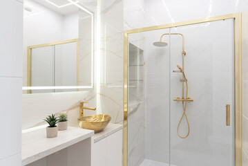 Wall Mural - Elegenat and luxurious interior bathroom with shower and bathtub and ceramic sink with golden faucet. Marble on the walland mirror in stylish bath.