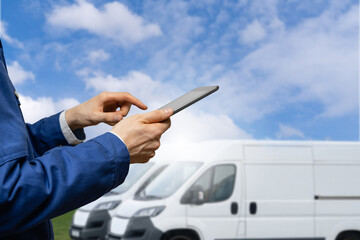 Poster - Manager with a digital tablet on the background of vans. Fleet management.