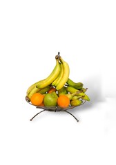 Fresh Fruit in Metal Bowl Holder With White Background. Apples And Oranges Under Hanging Bannanas Cut Out.