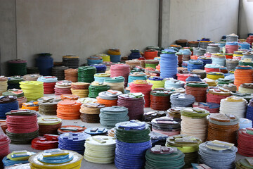 Room of glass factory full of colorful smalto discs for mosaic tiles.