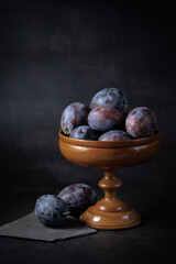 Ripe plums  on a dark background