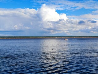 beautiful view of the river and people sailing on a boat