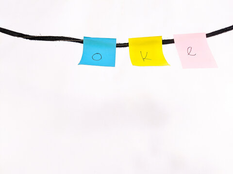 A set of isolated colorful sticky notes with the word okay