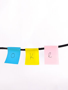 A set of isolated colorful sticky notes with the word okay