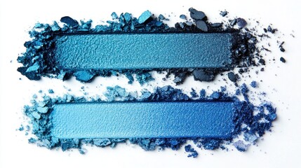 Wall Mural - Two shades of blue crushed eyeshadow swatches against a white background, showcasing a gradient from darker to lighter blue with scattered powder pieces.