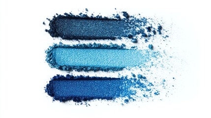 Three shades of blue eyeshadow swatches, crushed and powdery in texture, creating a gradient from light to dark on a white background.