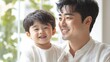 © Татьяна Креминская - Korean Father and Son Smiling Together on White Background, Family Bonding Moment