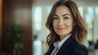 © Ace64 Studio - Closeup portrait mature professional beautiful confident woman wearing a power suit friendly personality smiling isolated indoors office background. positive human emotions.
