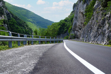 Canvas Print - Picturesque view of rocky cliff and asphalt road in mountains