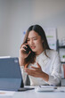 © amnaj - Stressed young asian businesswoman getting angry while talking on phone with client, having problem at work