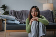 © amnaj - Young woman sits sadly at home, feeling lonely and lost in thought about her problems. She looks upset and tired, reflecting on her emotions and mental health. She needs support and therapy