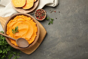 Wall Mural - Delicious mashed sweet potatoes served on gray textured table, flat lay. Space for text