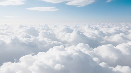 Wall Mural - White Clouds from above. Aerial view of the fluffy white cloud on blue sky. Top view from an airplane over white clouds in a blue sky. High in the Heavens.