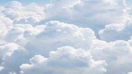 Wall Mural - White Clouds from above. Aerial view of the fluffy white cloud on blue sky. Top view from an airplane over white clouds in a blue sky. High in the Heavens.