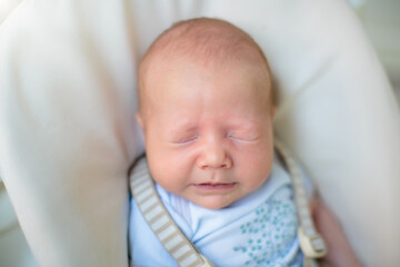 Wall Mural - Newborn baby boy in high chair